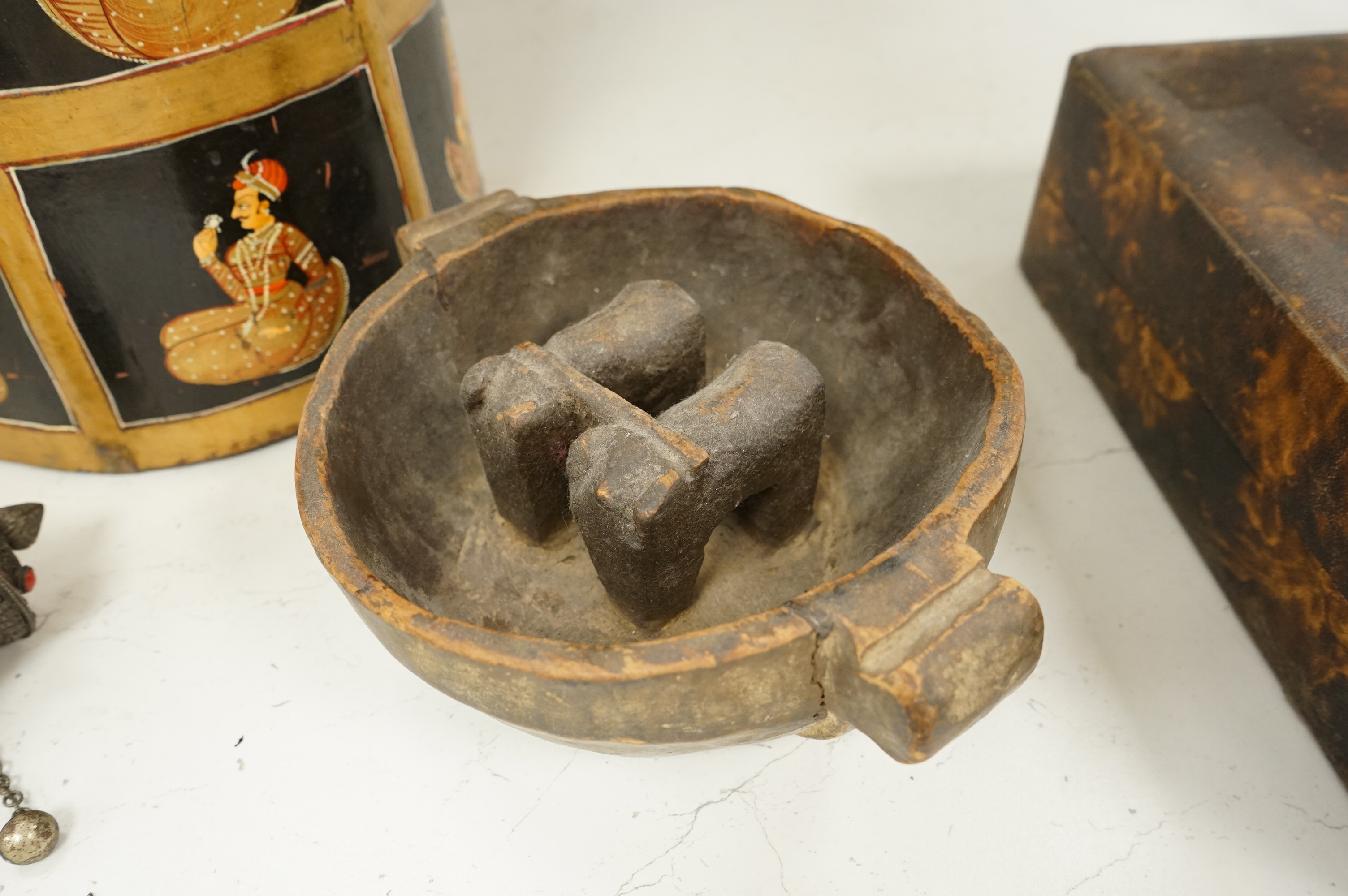 A collection of tribal and Asian collectables including a Tibetan prayer wheel, carvings, etc.